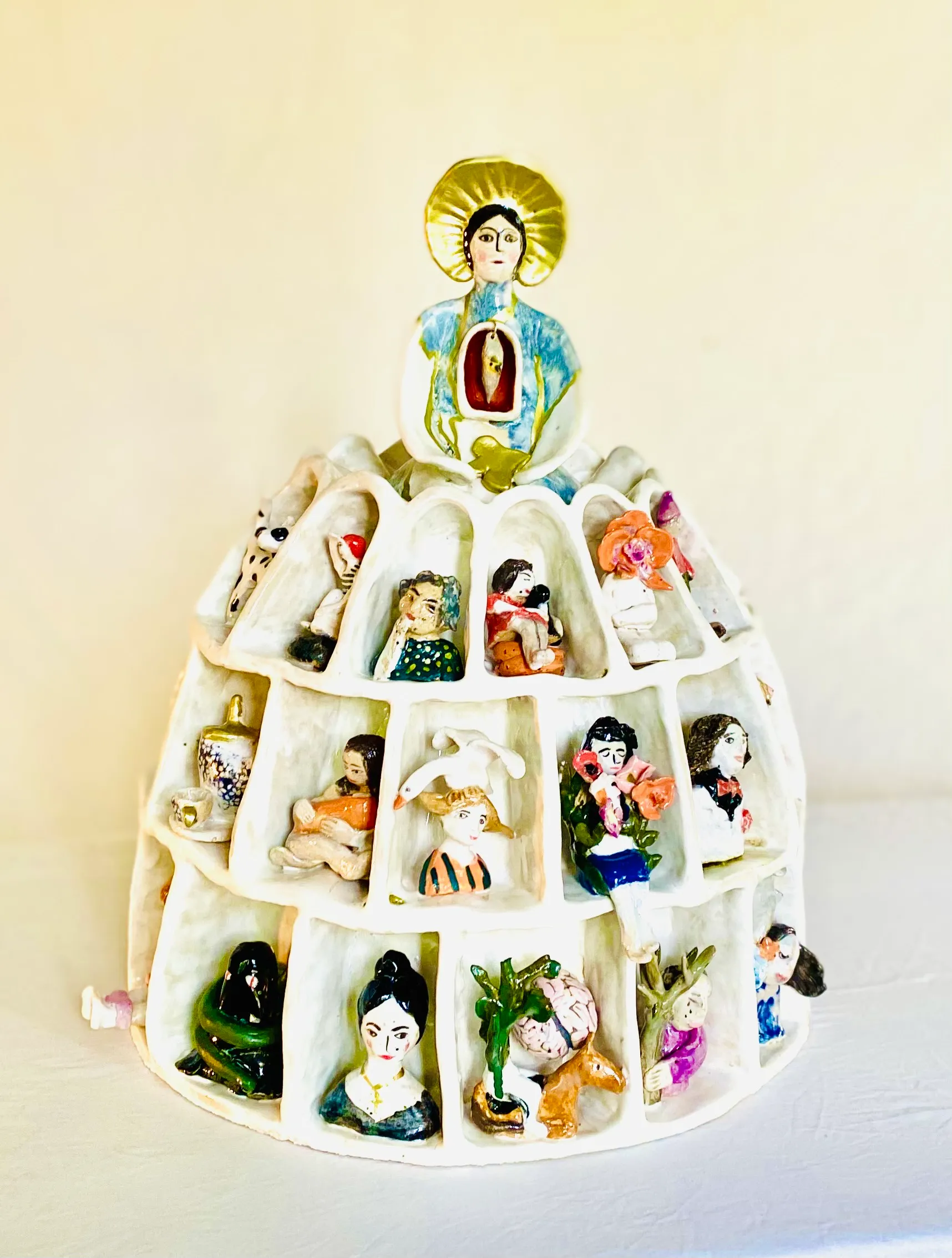 A clay figure of a woman whose skirt contains her ‘internal family’, representing IFS.